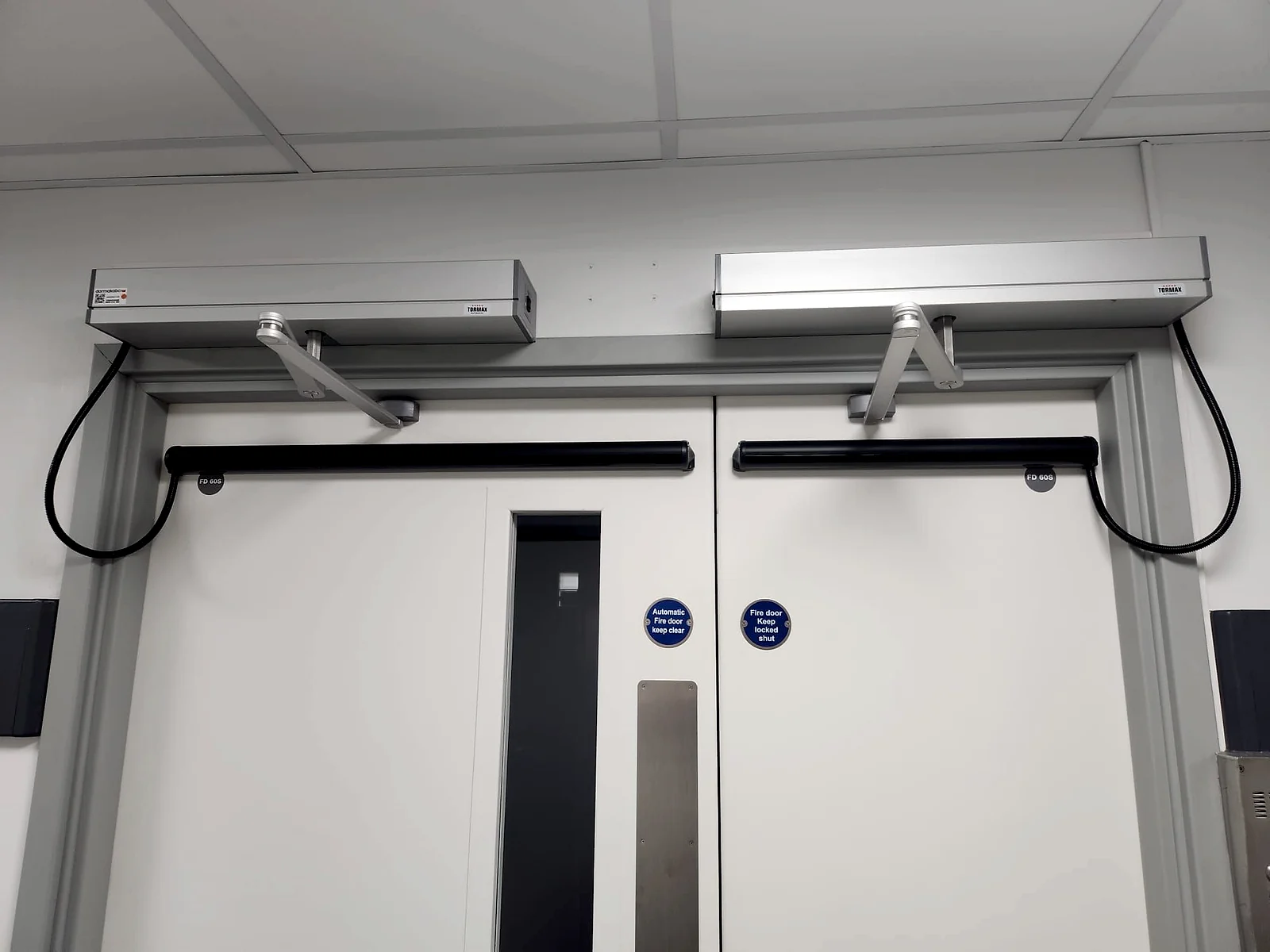New automatic swing door operators fitted to a rated double fire door